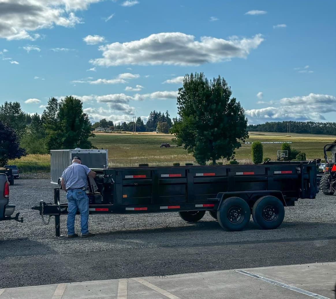 An Inexpensive Tree Care team members helping a customer with a Dump Truck Rental in Portland, OR.